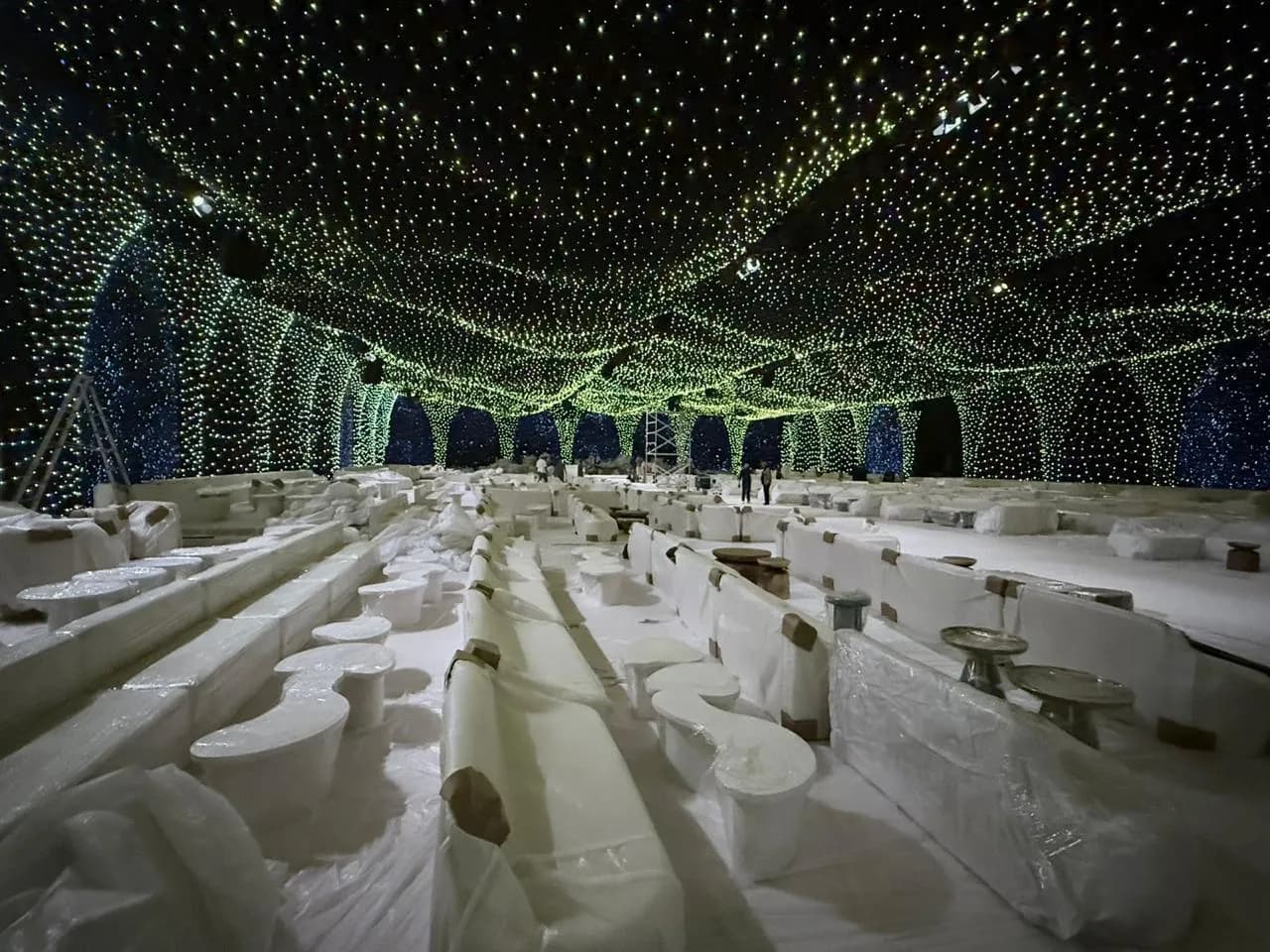 A starlit-canopy installation over a formal banquet floor, staged by our partner production network